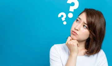 Lady looking confused with question marks around her head